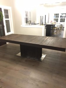 Custom dining table with leaf insert made from reclaimed barn wood in Bend, OR.