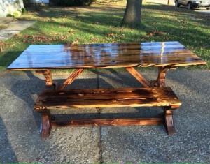 Handmade pine table made from pine. The dark grain in the wood was a result from burning the wood.